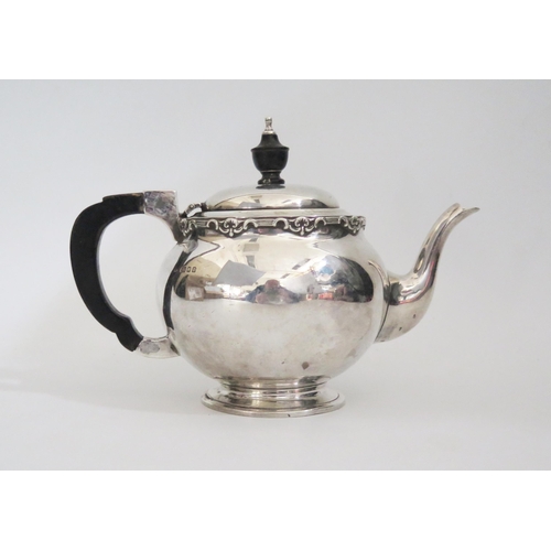 607 - An Arts and Crafts silver teapot, of bullet shape, with ebonised handle and finial, 15cm high, 428gr... 