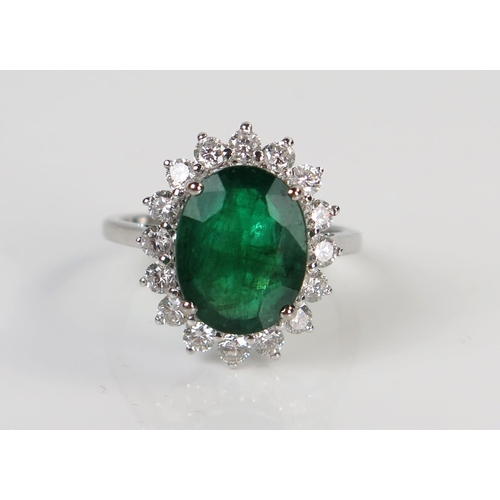 61 - Modern 18ct White Gold, Emerald and Diamond Cluster Ring, size N, 4.6g. Central stone c. 12x9.3mm, 1... 