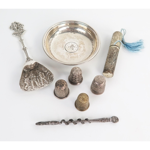 625 - Sewing interest: three silver thimbles, a plated thimble, a plated needle case, an Egyptian pin dish... 