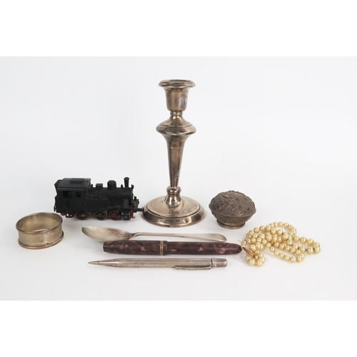 633 - A mixed lot comprising of a silver candlestick, loaded, silver napkin ring, silver scent bottle stop... 