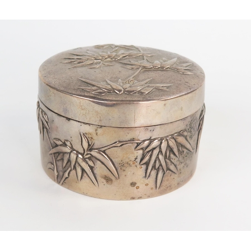 643 - A Chinese silver dressing table box, of circular form, pull off lid, decorated with bamboo, 5x8.3cm,... 