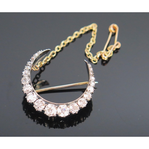 66 - Victorian Diamond Crescent Brooch with safety clasp in an unmarked precious metal setting, 23mm diam... 