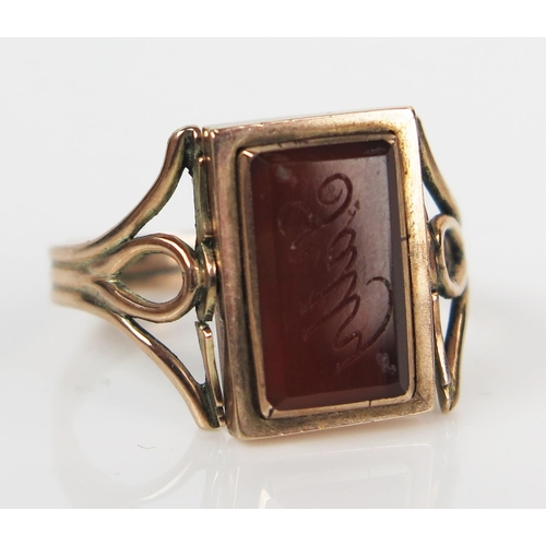 74 - Bloodstone and Orange Agate Revolving Ring in an unmarked gold setting, the agate engraved 