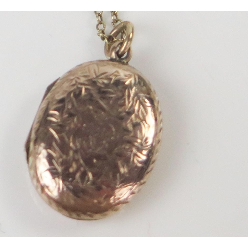 96 - Antique 9ct Gold Locket with chased foliate decoration (26mm drop) and on a 18.5