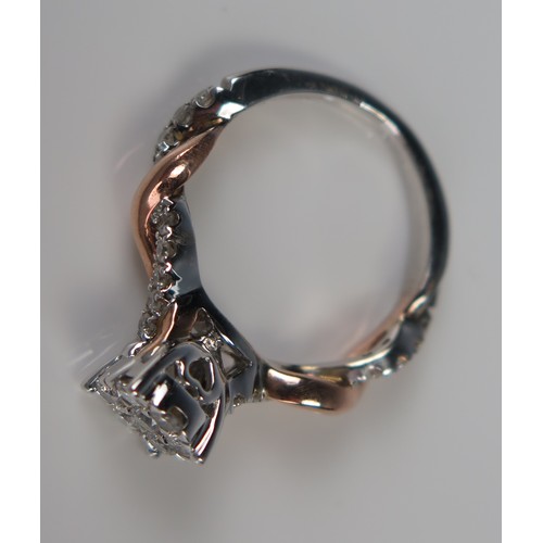 141 - 10K Rose and White Gold Multi Stone Ring, the 7mm  head set with seven round cuts and further to the... 