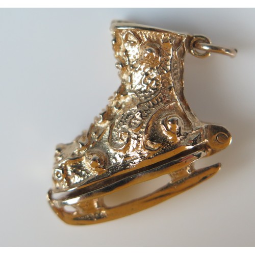 145 - 9ct Gold Charm in the form of an ice skating boot with hinged heel opening to reveal a female ice sk... 