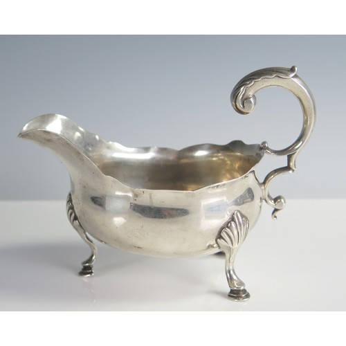 651 - George III Silver Sauce Boat with foliate scroll handle and standing on three hoof feet, 14.5cm long... 