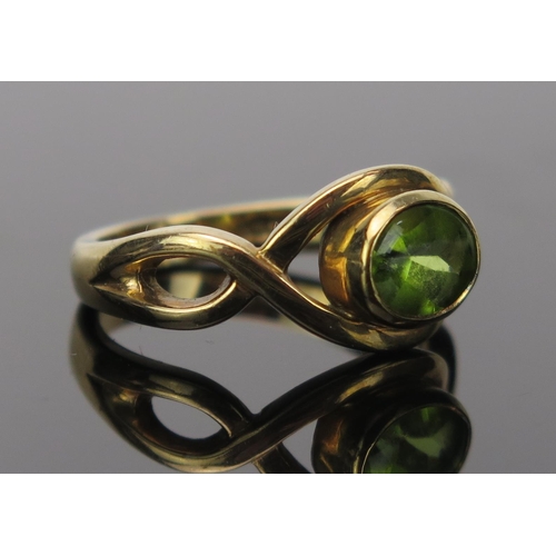 11 - Peridot Dress Ring in an unmarked gold setting, size O.5, 4.8g