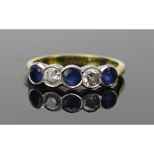 13 - Sapphire and Diamond Five Stone Ring in an 18ct hallmarked rub over setting, c. 3.8mm stones, 19mm h... 