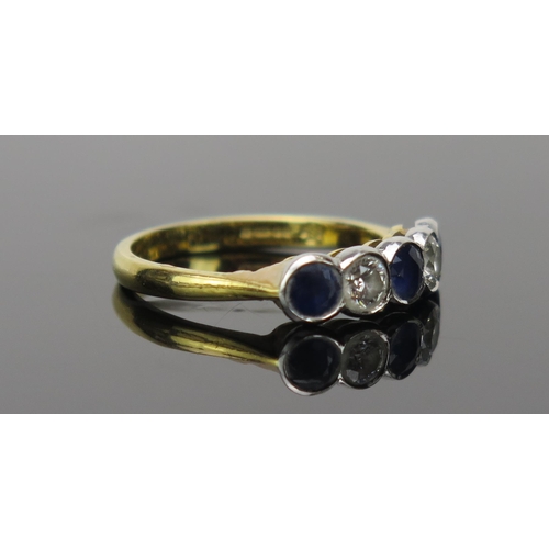 13 - Sapphire and Diamond Five Stone Ring in an 18ct hallmarked rub over setting, c. 3.8mm stones, 19mm h... 