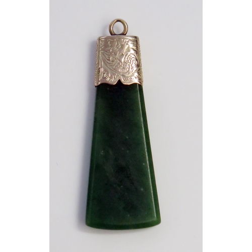 15 - Antique Nephrite Axe Shaped Pendant in an unmarked gold setting with chased foliate decoration, 51.5... 