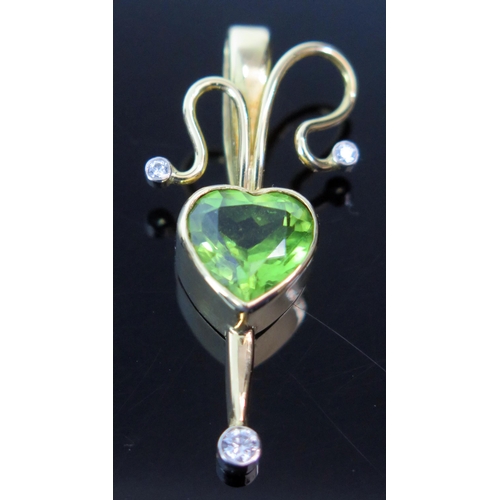 18 - Peridot and Diamond Pendant in an 18ct hallmarked gold setting, 34.5mm drop, 4.2g