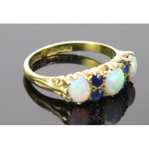 21 - White Opal and Sapphire Ring in an 18ct hallmarked gold setting, 17mm head, size K.75, Birmingham 19... 