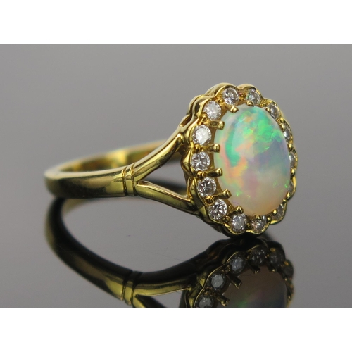 23 - White Opal and Diamond Cluster Ring in an 18ct hallmarked gold setting, 9x7mm central stone, 13x11mm... 