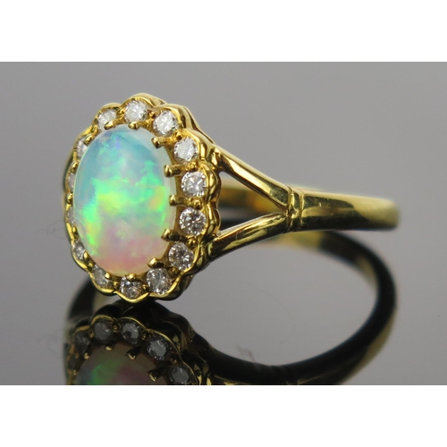 23 - White Opal and Diamond Cluster Ring in an 18ct hallmarked gold setting, 9x7mm central stone, 13x11mm... 