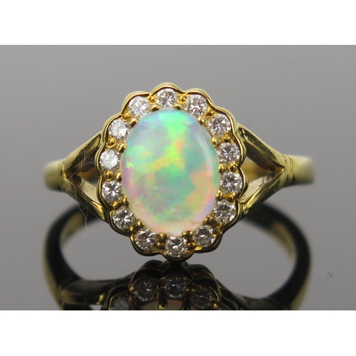 23 - White Opal and Diamond Cluster Ring in an 18ct hallmarked gold setting, 9x7mm central stone, 13x11mm... 