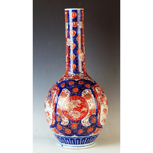 232 - Japanese Meiji Period Imari vase  of bottle form, decorated with garden scenes, 51cm 20 1/4inches.