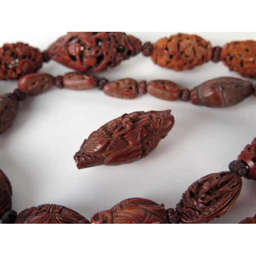 246 - Late 19th Century Chinese Carved Nut Bead necklace, 24 beads, including Hediao nut, together with a ... 