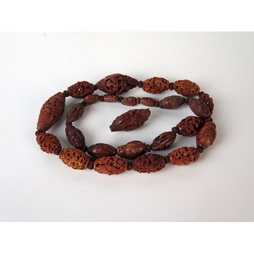 246 - Late 19th Century Chinese Carved Nut Bead necklace, 24 beads, including Hediao nut, together with a ... 