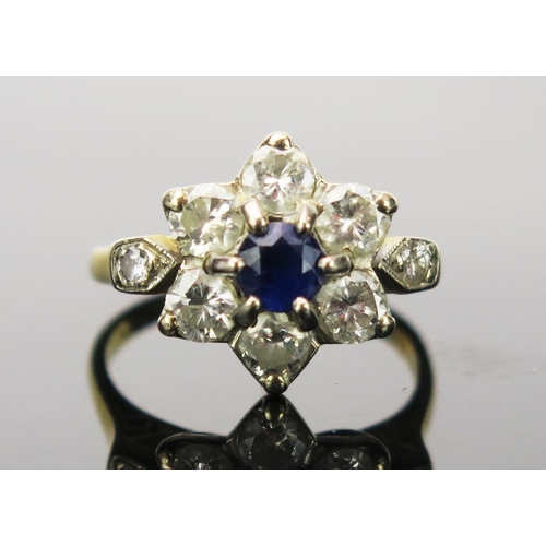 29 - Sapphire and Diamond Cluster Ring with millegrain set shoulders in an 18CT stamped gold setting, 17.... 