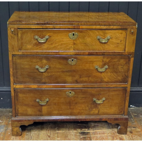 403 - Walnut Bachelors Chest, the foldover top with pull out supports, three long drawers, raised on brack... 