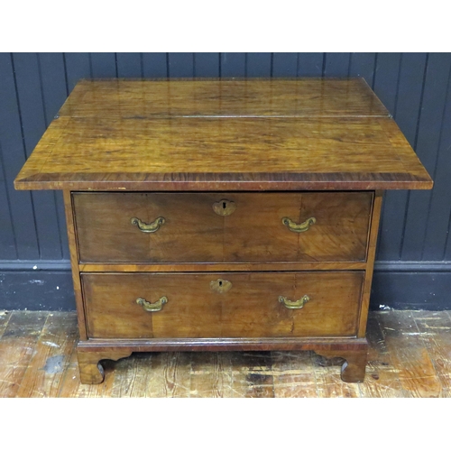 403 - Walnut Bachelors Chest, the foldover top with pull out supports, three long drawers, raised on brack... 