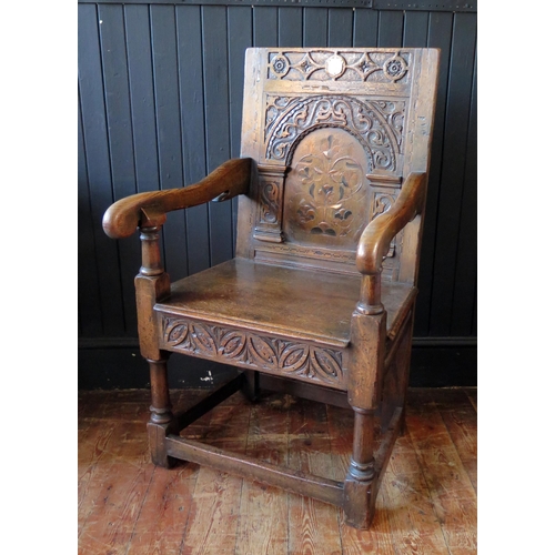 405 - 17th Century Style Oak Panel Back Armchair, carved Arcadian back inlaid central decoration, 59cm wid... 