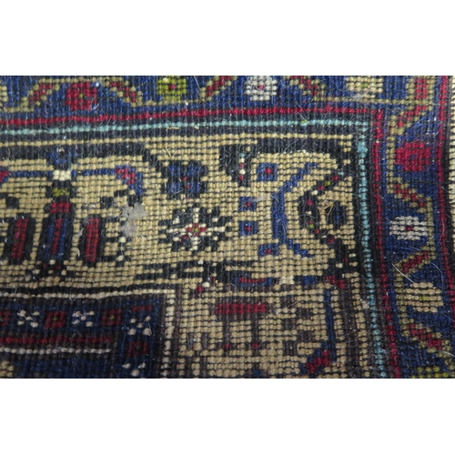 409 - A late 20th Century Persian style wool rug, red and dark blue, 188x109cm.