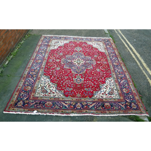 410 - A 20th Century Kashan style wool carpet, blue central medallion, red field, cream spandrels, blue bo... 