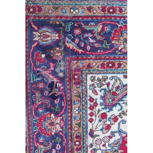 410 - A 20th Century Kashan style wool carpet, blue central medallion, red field, cream spandrels, blue bo... 