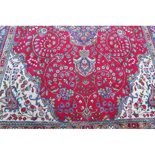 410 - A 20th Century Kashan style wool carpet, blue central medallion, red field, cream spandrels, blue bo... 