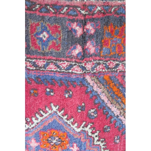 412 - A large 20th Century Turkish Runner, wool carpet, geometric diamond lozenges, red ground, pyramid gr... 