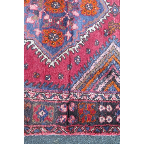 412 - A large 20th Century Turkish Runner, wool carpet, geometric diamond lozenges, red ground, pyramid gr... 