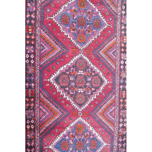 412 - A large 20th Century Turkish Runner, wool carpet, geometric diamond lozenges, red ground, pyramid gr... 