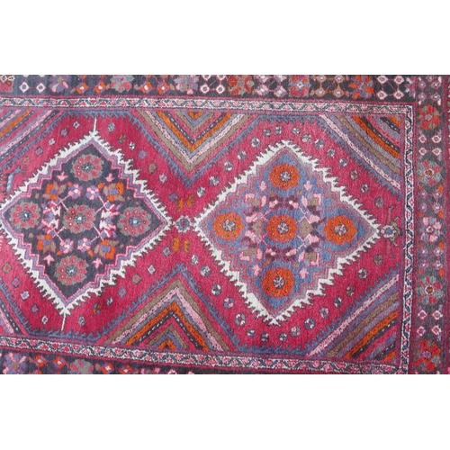 412 - A large 20th Century Turkish Runner, wool carpet, geometric diamond lozenges, red ground, pyramid gr... 