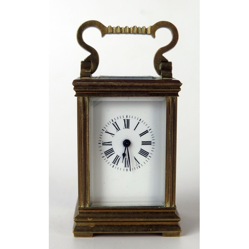 62 - A late 19th century French miniature brass carriage timepiece, with 3cm enamel Roman dial, the movem... 