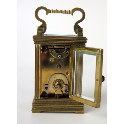 62 - A late 19th century French miniature brass carriage timepiece, with 3cm enamel Roman dial, the movem... 