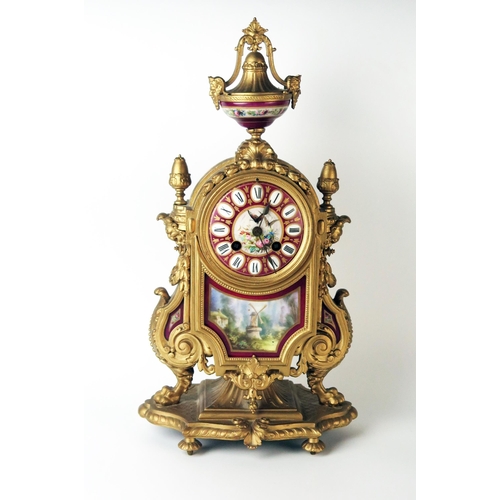 66 - A late 19th century French gilt metal an porcelain mounted mantel clock of arched outline, with urn ... 