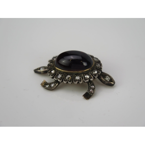 1001 - A Victorian cabochon garnet and rose cut diamond articulated en trembler brooch in the form of a ter... 