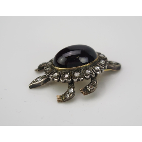 1001 - A Victorian cabochon garnet and rose cut diamond articulated en trembler brooch in the form of a ter... 