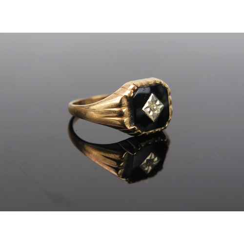 1015 - A 9ct Gold, Onyx and Diamond signet ring, 2.8g total, ring size approximately R.