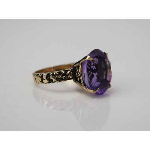 1040 - A Gold and Amethyst Cocktail Ring, claw set stone 14x12mm, textured shoulders, not marked, 6.09gms, ... 