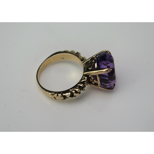 1040 - A Gold and Amethyst Cocktail Ring, claw set stone 14x12mm, textured shoulders, not marked, 6.09gms, ... 