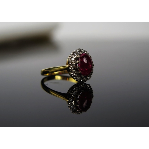 1048 - A Red Stone and Diamond chip 18ct gold ring, the cabochon stone approximately 6cm long, stamped 750,... 