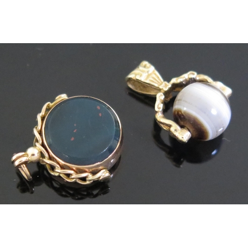 1074 - Two 9ct Gold and Agate spinning fobs, (2).