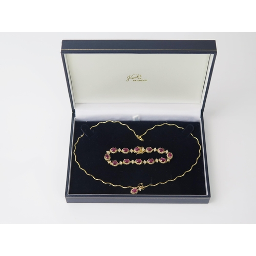 1101 - A modern gold and Ruby suite, comprising of a wavy gold necklace with ruby and diamond pendant, ruby... 