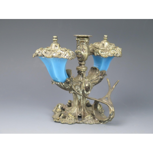 1142 - A late 19th century inkstand of floral design, with central taperstick flanked by two blue glass ink... 