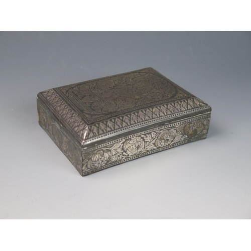 1173 - A Persian white metal and niello casket, of rectangular outline, with all over floral decoration 11c... 