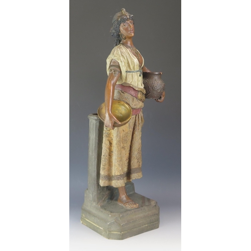 1656 - A late 19th century terracotta figure of a Nubian female water bearer, with polychrome decoration, 5... 
