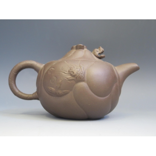 1667 - A Chinese Yixing pottery teapot, of squat circular form, decorated with dragons amongst clouds, the ... 